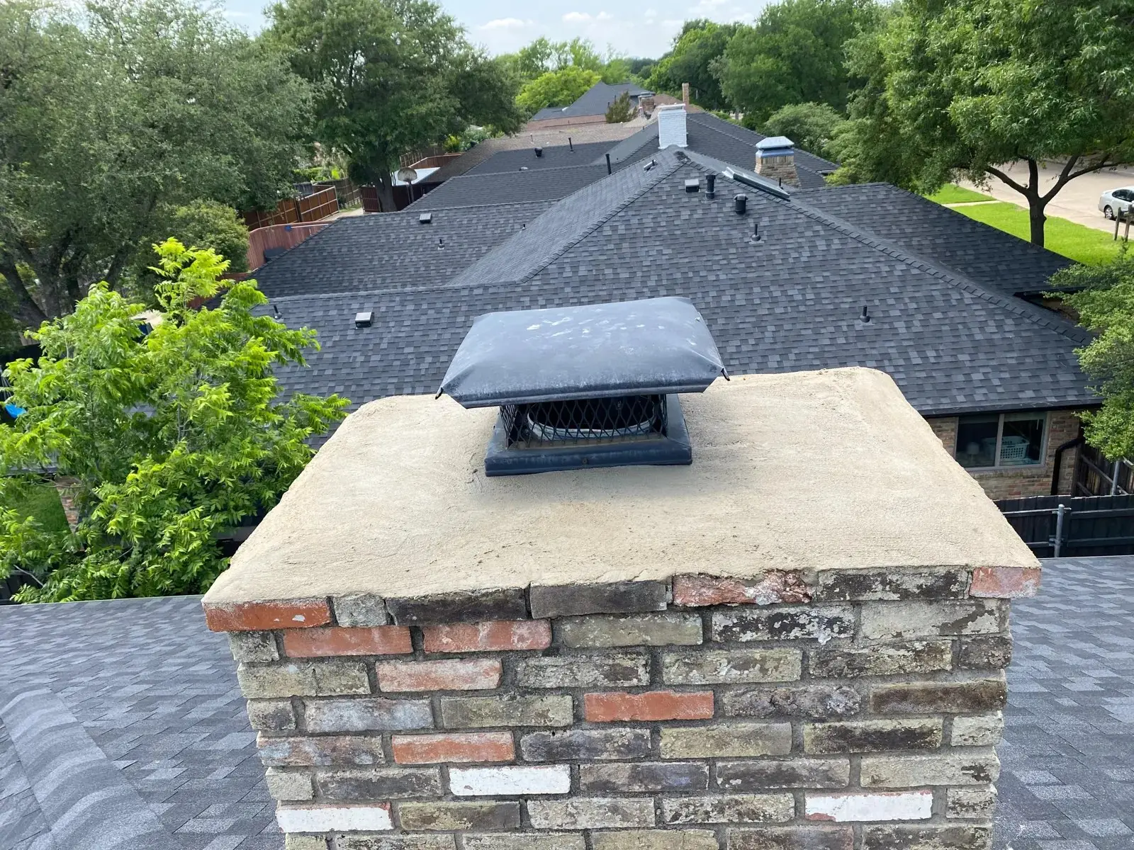 Chimney cap on a repaired crown of a brick chimney, installed by Ember