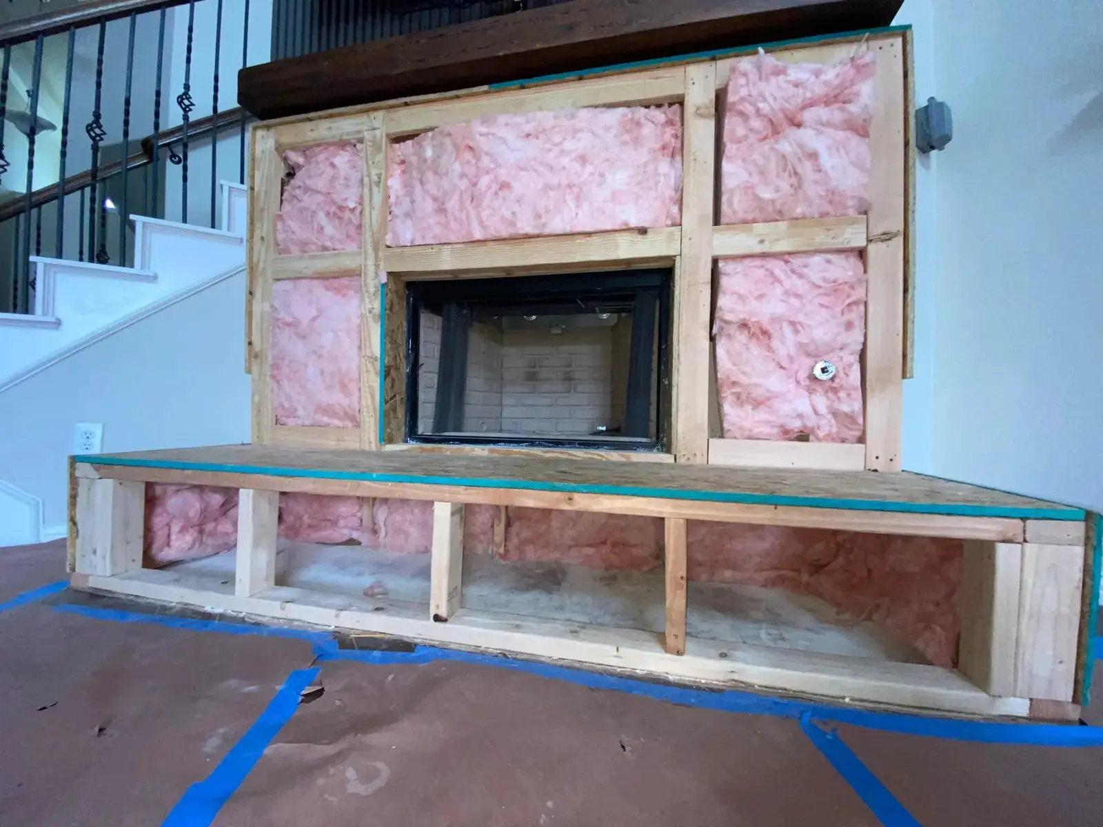 Fireplace insert being framed in during a DFW installation