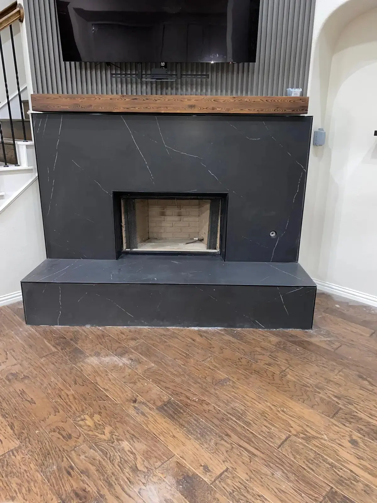 New fireplace and stone surround installed by Ember Chimney & Fireplace