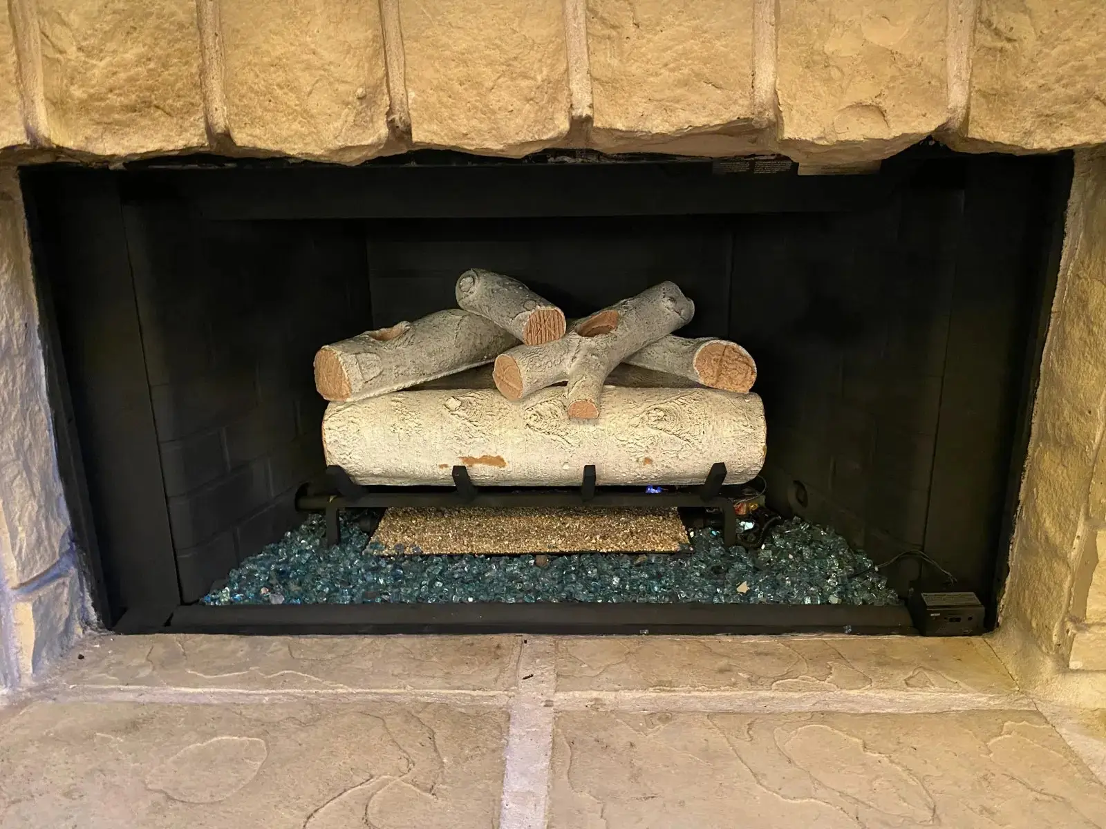Finished gas log installation in a brick firebox