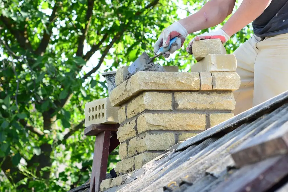 Masonry repair on a stone chimney