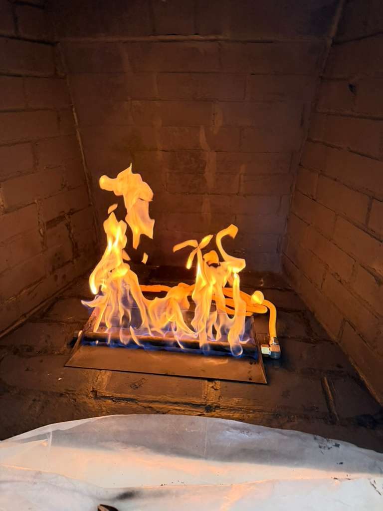 Gas fireplace burning indoors in a Dallas-Fort Worth home, serviced by Ember Chimney & Fireplace