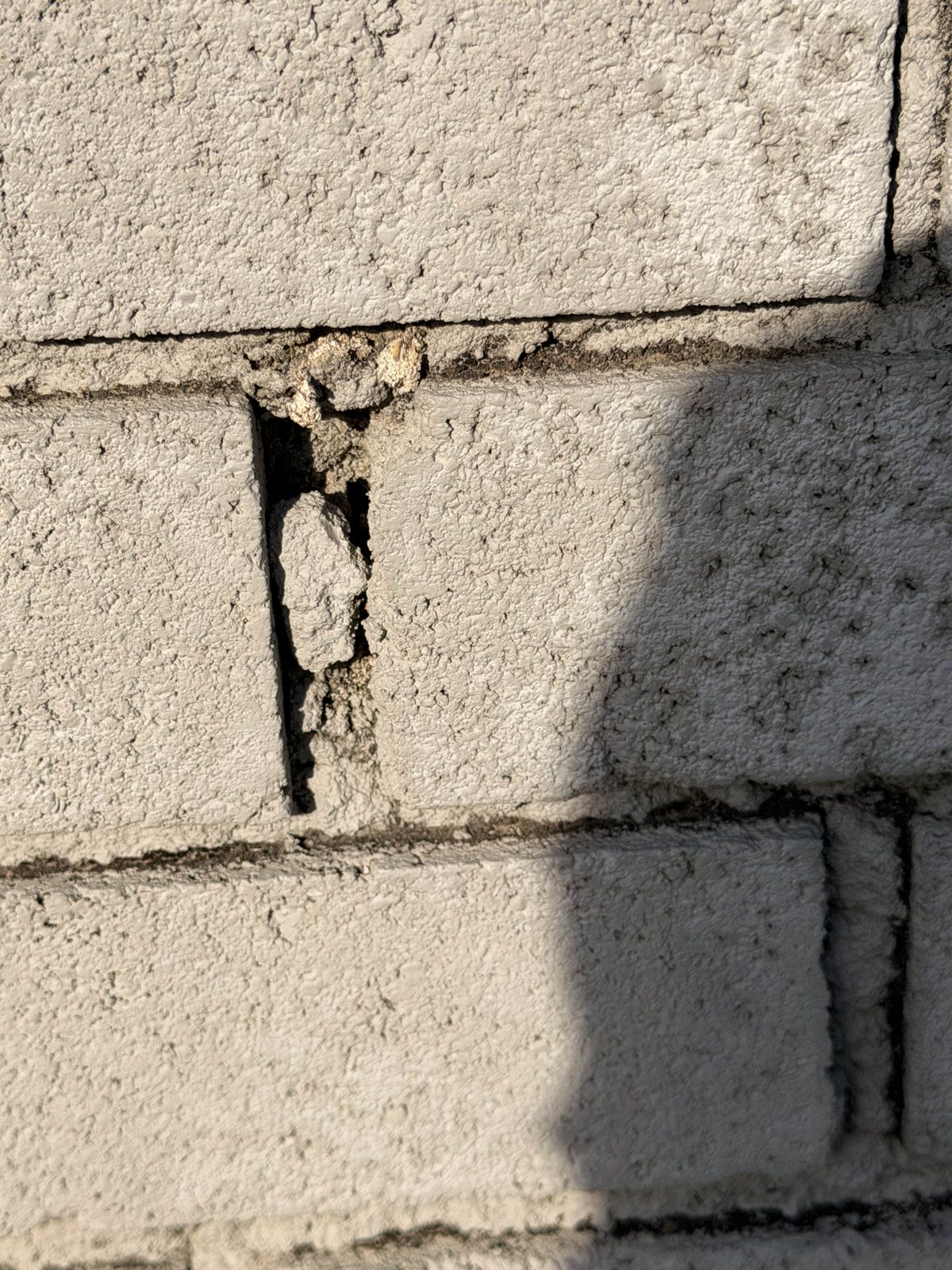 Crumbling mortar joint between bricks on a Dallas-Fort Worth chimney, found by Ember Chimney & Fireplace during an inspection